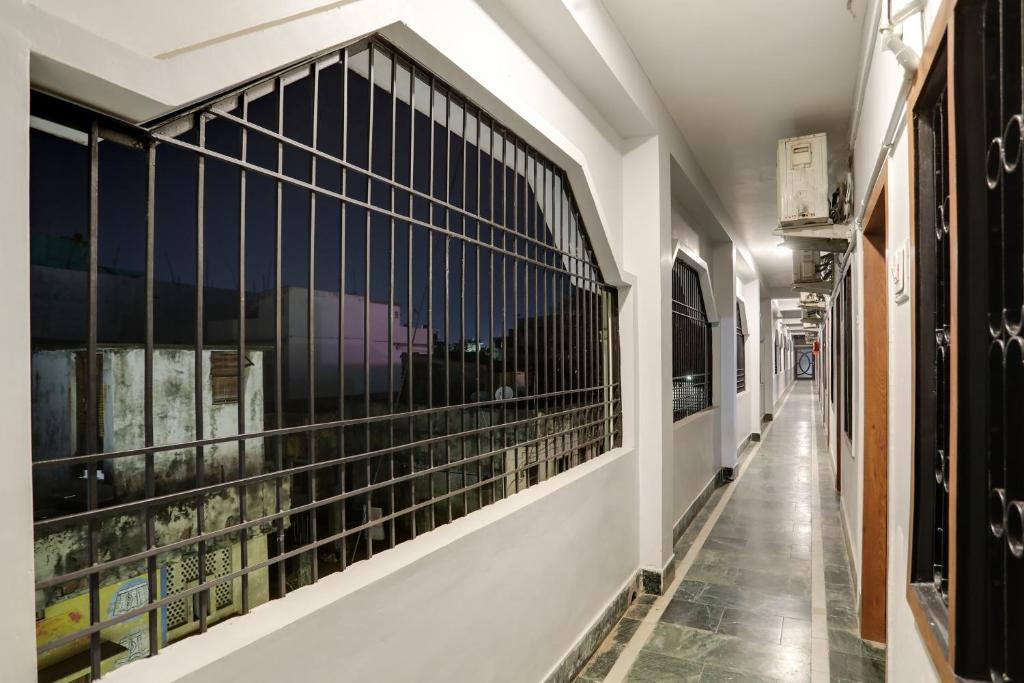 a corridor of a building with black barred windows at Flagship Shree Ram Residency in Cuttack