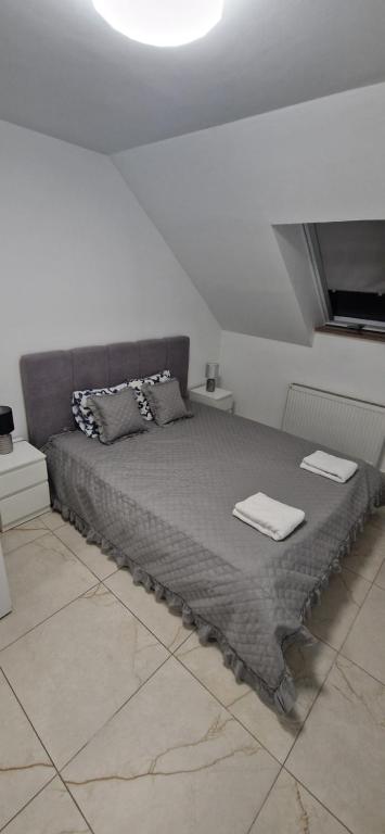 a bed in a white room with two pillows on it at ewja 4 in Sulęcin