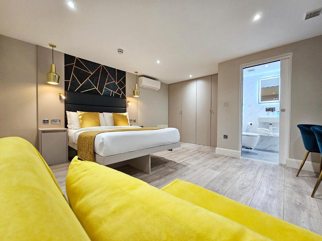 a hotel room with two beds and a bathroom at NOX Hyde Park in London