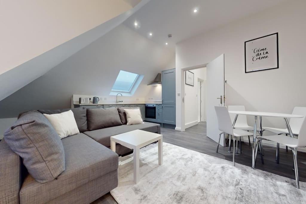 a living room with a couch and a table at LONDON STAY Flats in London