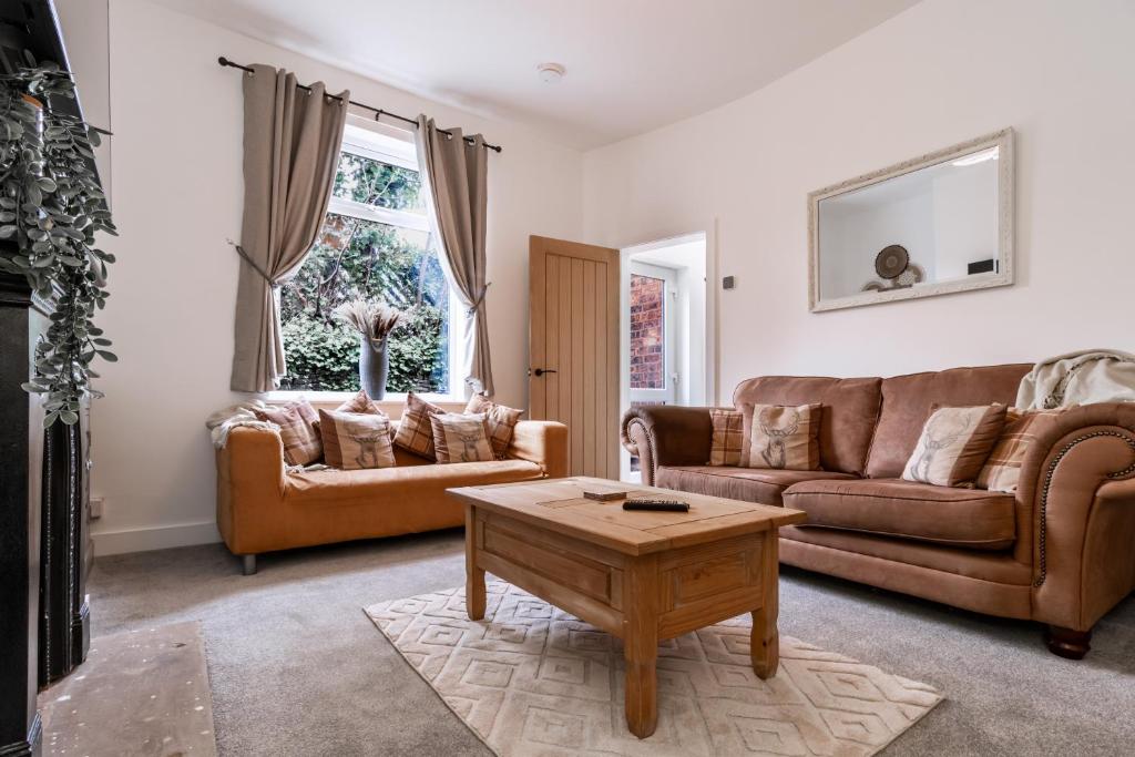 a living room with two couches and a coffee table at Railway Retreat in Wakefield