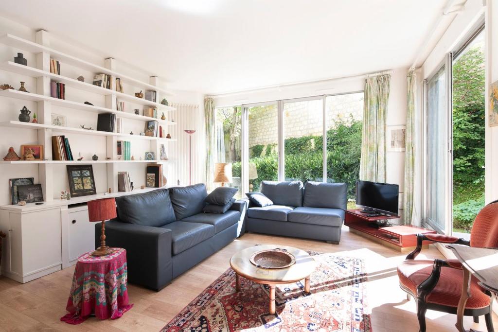 a living room with a couch and a table at GuestReady - Prime haven in Montparnasse in Paris