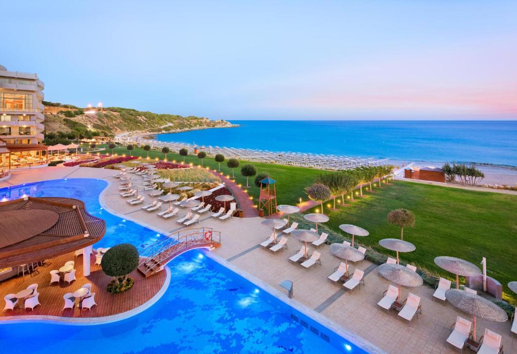 an aerial view of a resort with a pool and the ocean at Elysium Resort & Spa in Faliraki
