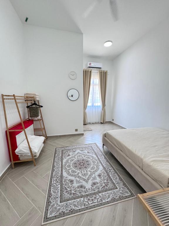 a bedroom with a bed and a rug on the floor at RoomAH Sura Jetty in Kampong Pak Sabah