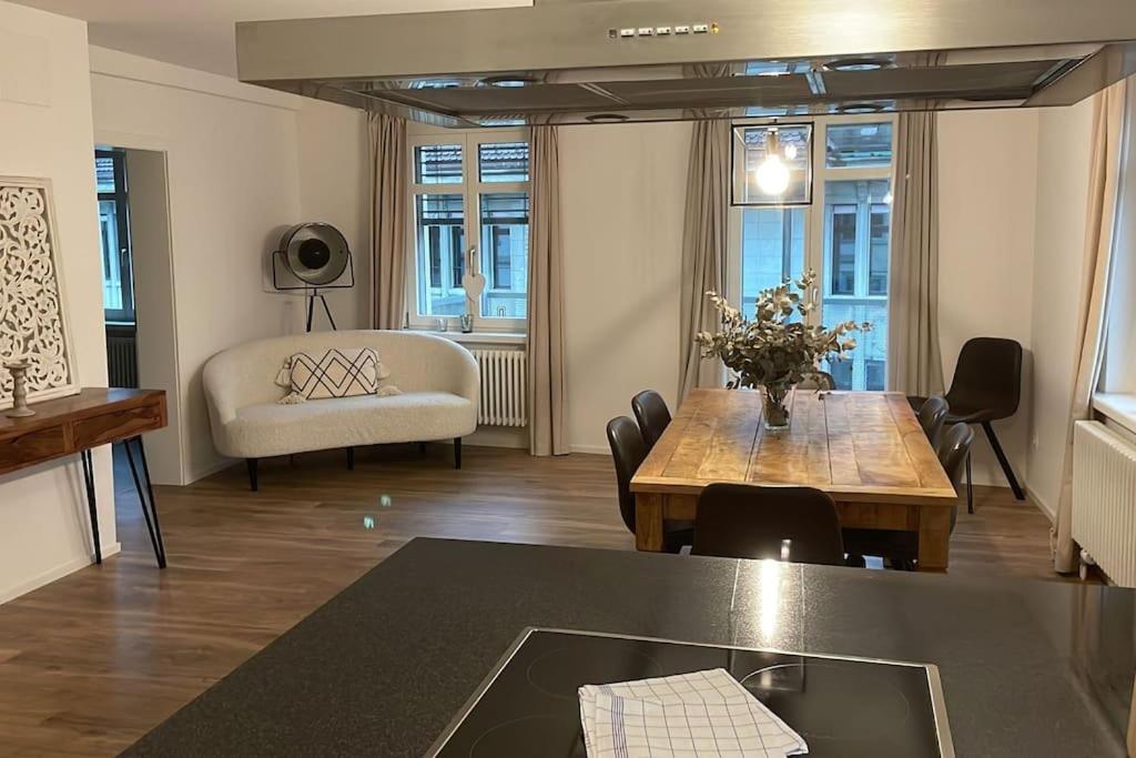 a living room with a table and a couch at Amazing two bedroom Penthouse in the city centre (Canal1) in Zurich