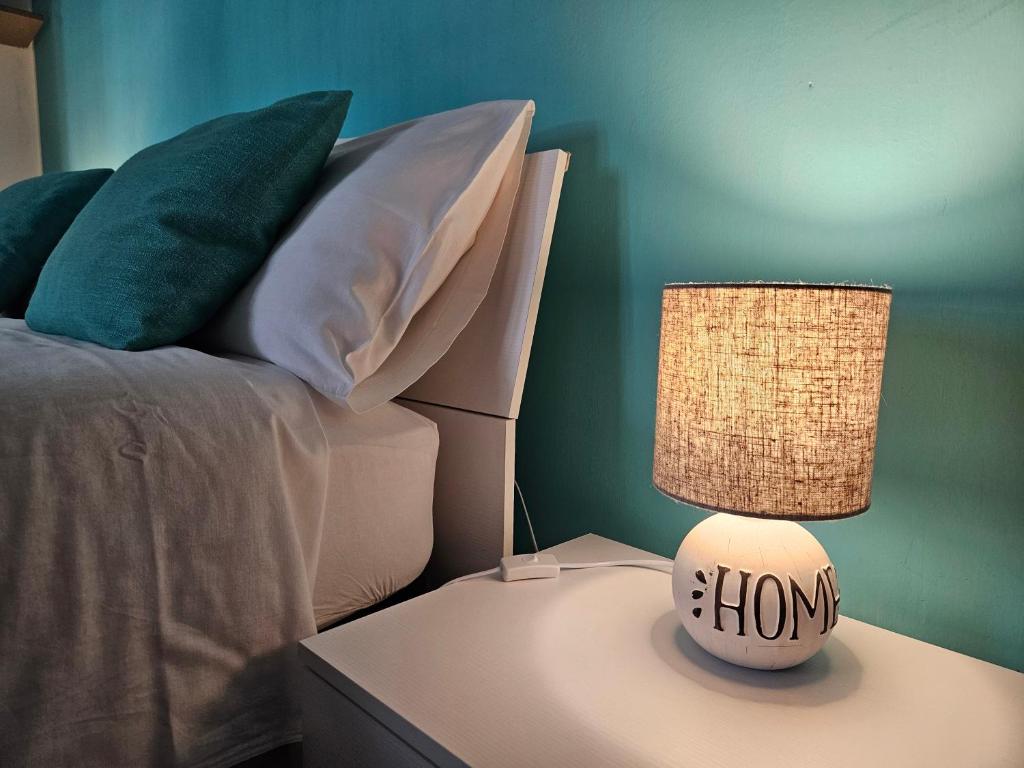 a lamp on a night stand next to a bed at Colazione da Tiffany in Bussolengo