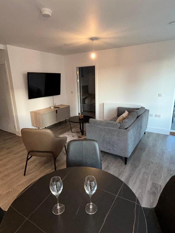 a living room with a couch and a table at Immaculate 2-Bed Apartment in Canning Town in London
