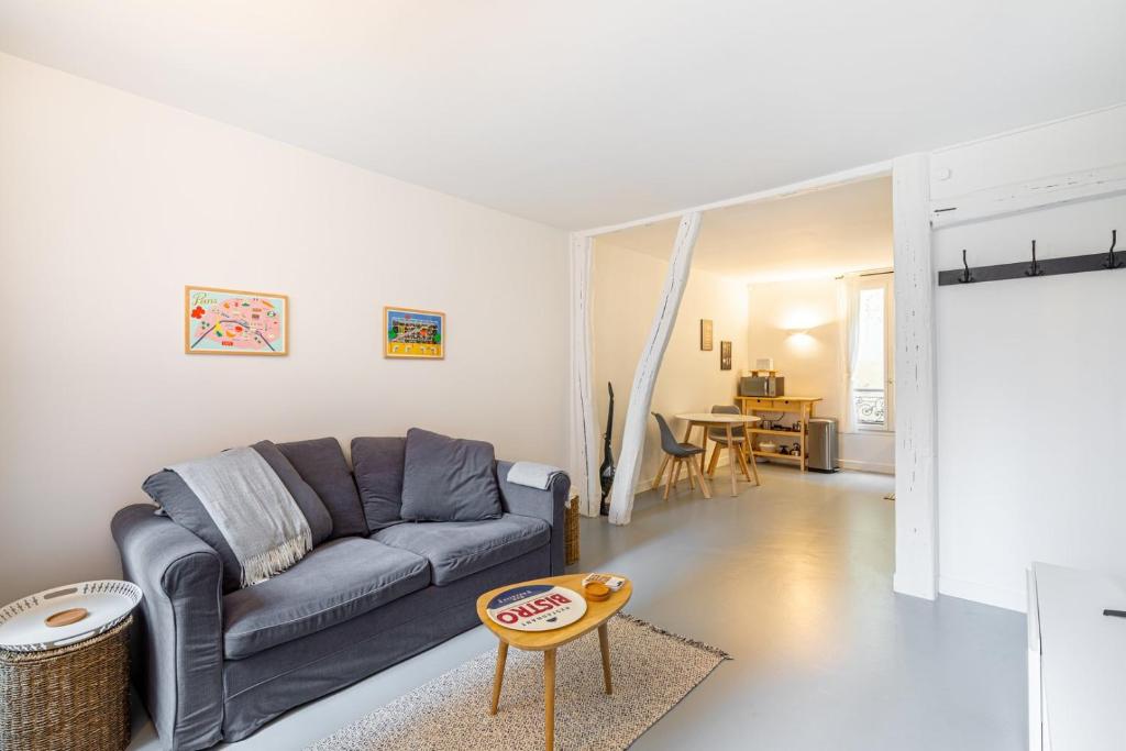 a living room with a couch and a table at GuestReady - Patriotic Blank Canvas near Louvre in Paris