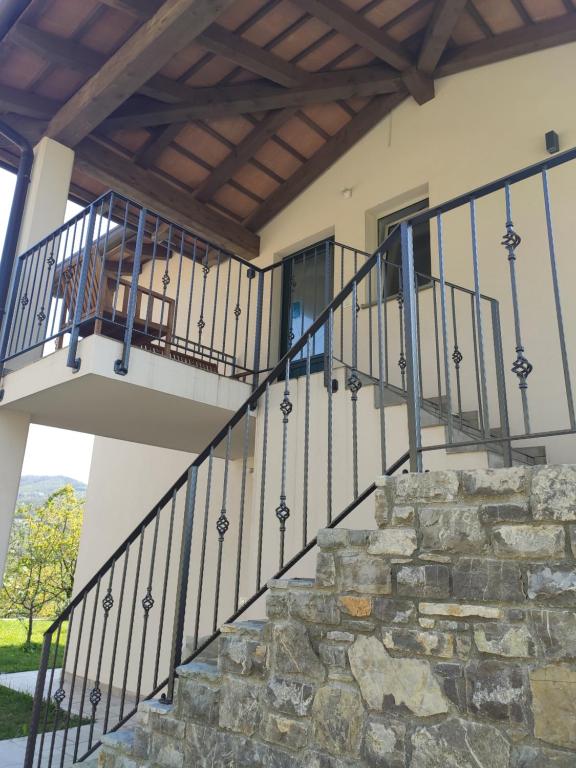 a balcony of a house with a stone staircase at Sobe Lavanda in Kojsko
