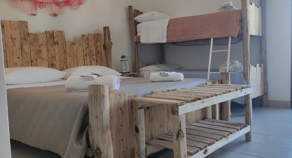 a bedroom with two bunk beds with a ladder at B&B Extremo Sud in Portopalo