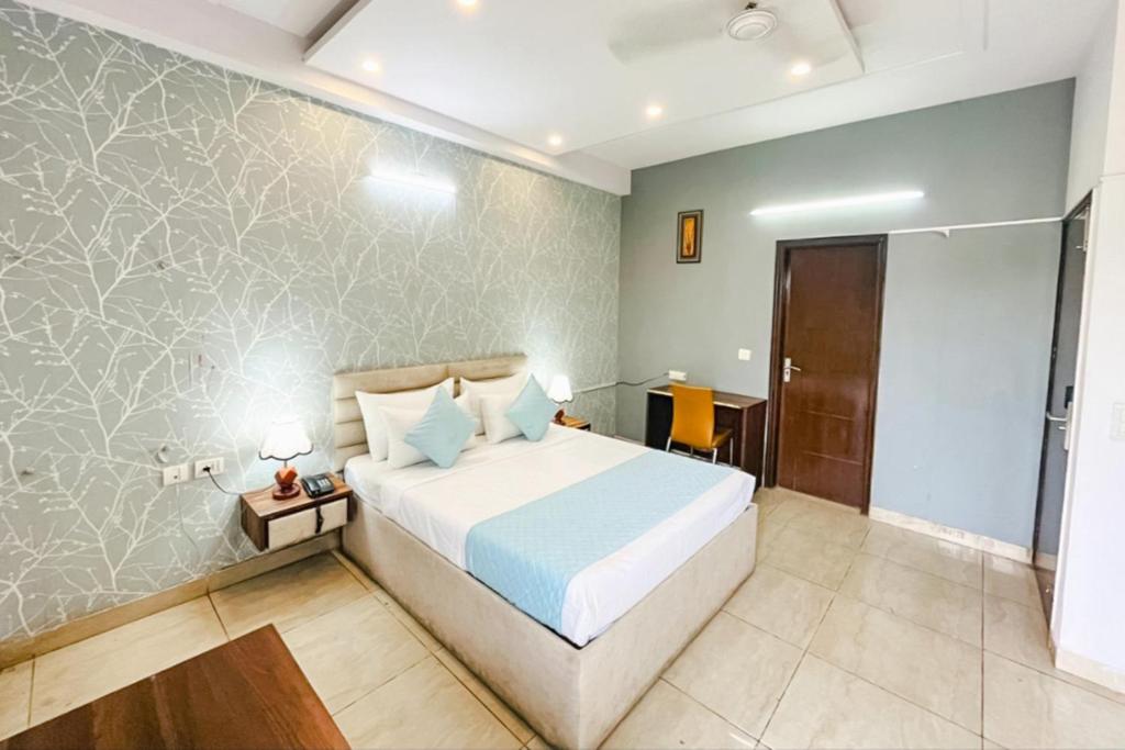 een slaapkamer met een groot bed in een kamer bij FabExpress Comfirt Inn in Noida