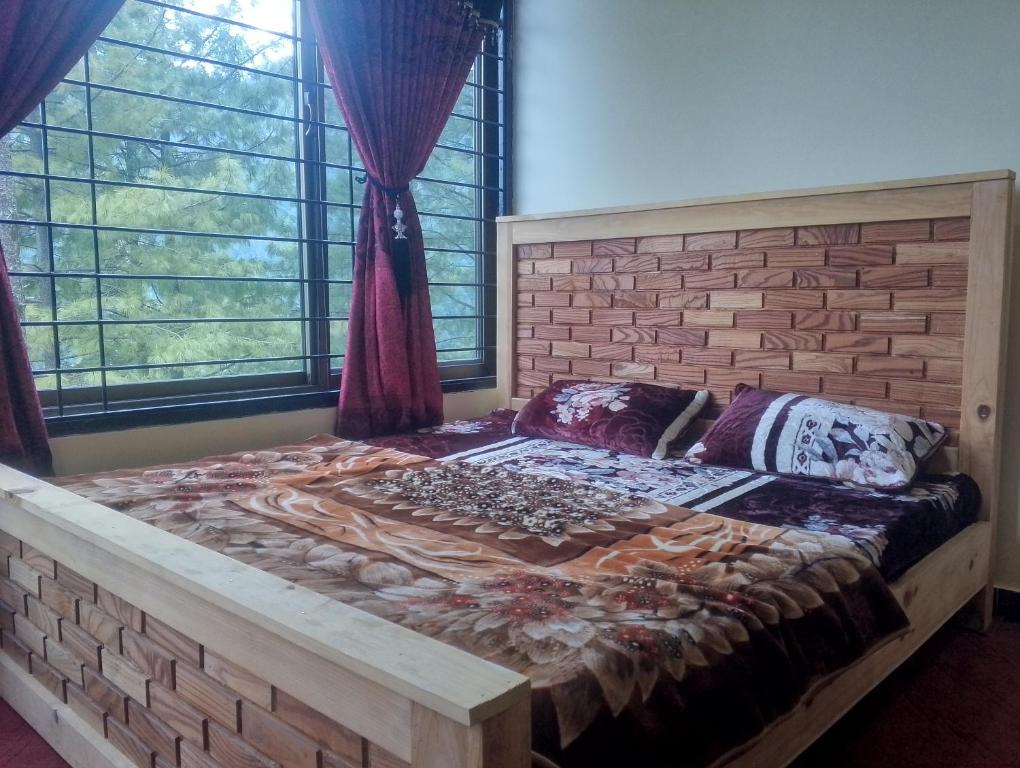 a bed in a room with a brick wall at Hill Heaven Resort in Abbottabad