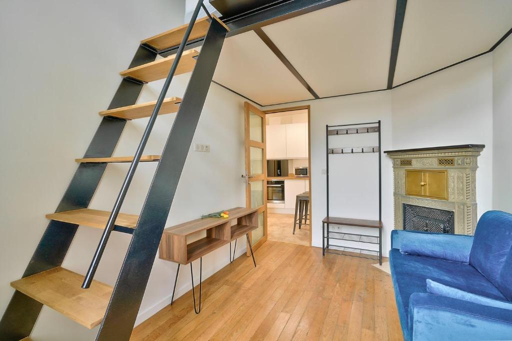 a living room with a ladder and a blue couch at GuestReady - Beautiful Apt near Paris Zoo in Paris