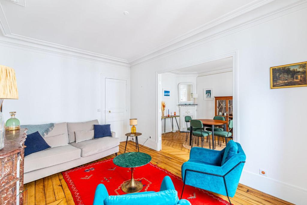 - un salon avec un canapé blanc et des fauteuils bleus dans l'établissement GuestReady - Douceur Parisienne dans le 15e arr., à Paris