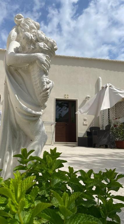 a statue of a woman with her arms crossed at Casacecilia relax in Syracuse