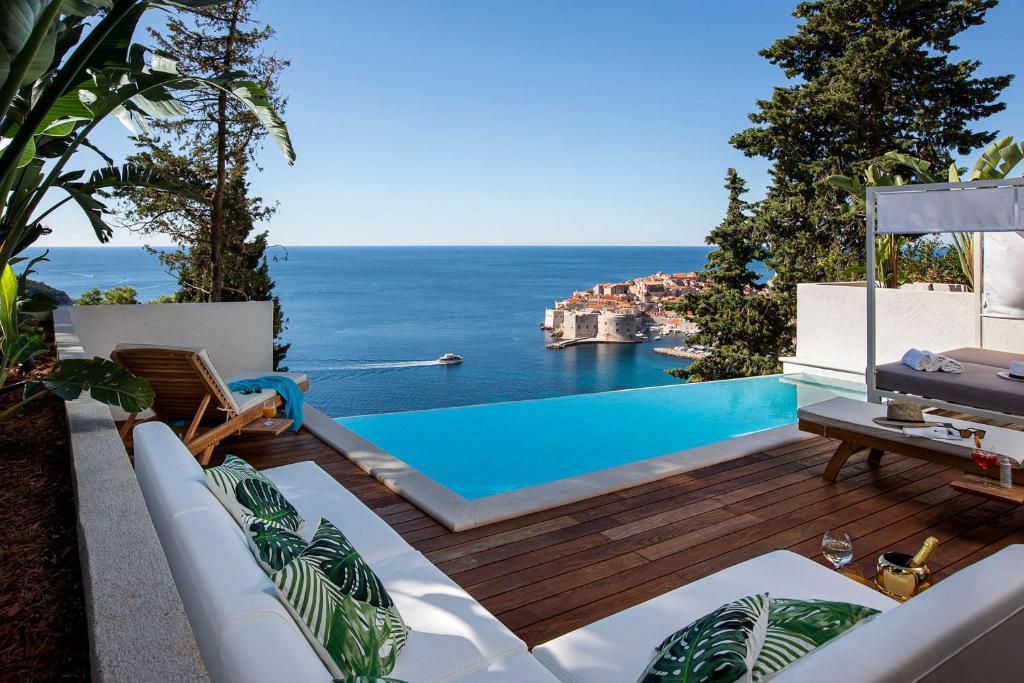a patio with a swimming pool and the ocean at Dubrovnik luxury apartments in Dubrovnik