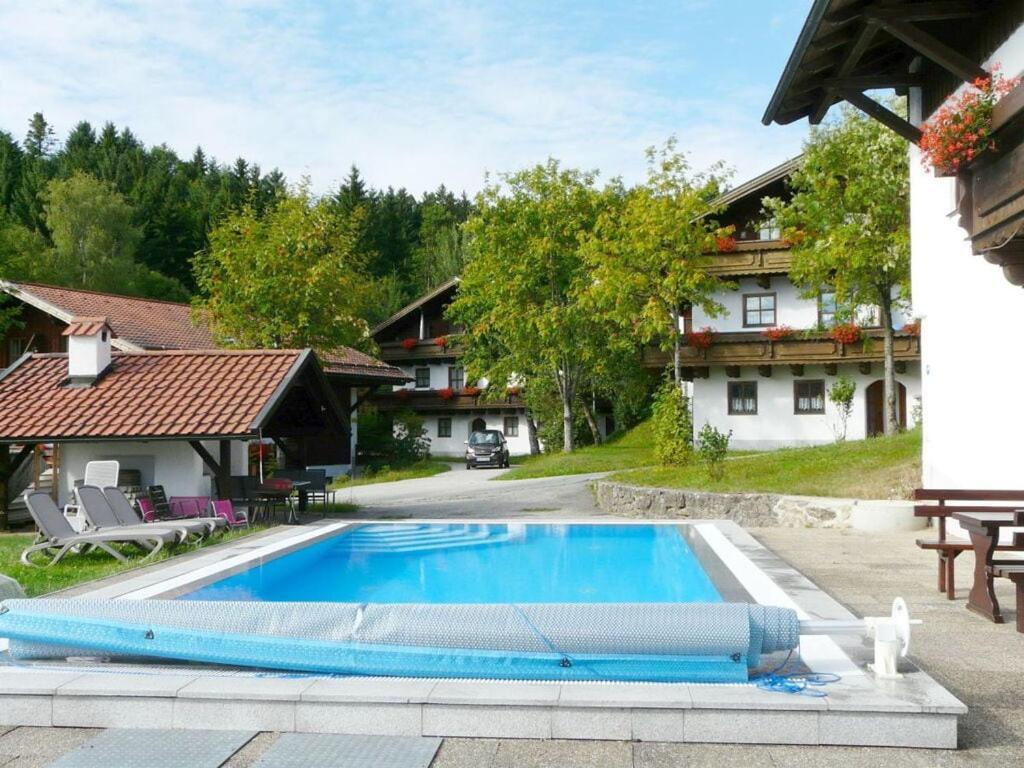 a swimming pool in front of a house at Hauzenberg App 303 in Freudensee
