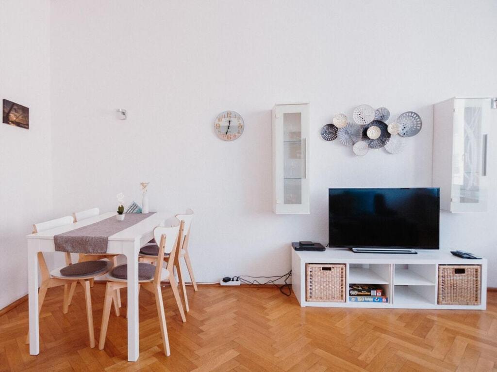a living room with a white table and a television at Sterkrade 1 Modern retreat in Oberhausen