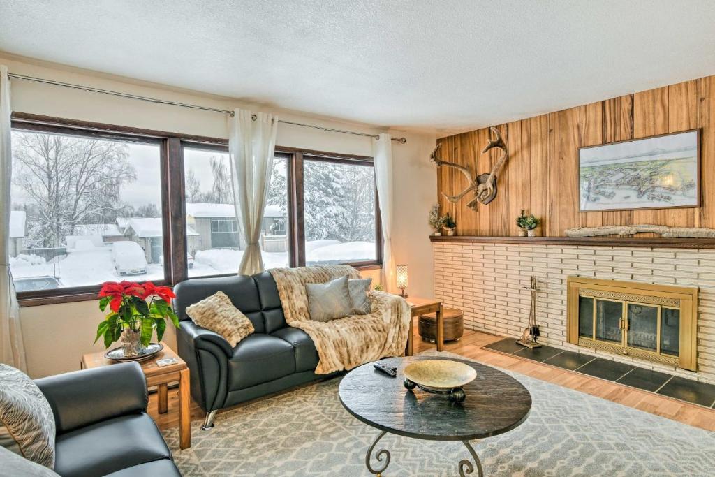 a living room with a couch and a fireplace at West Anchorage Home Near Airport! home in Anchorage