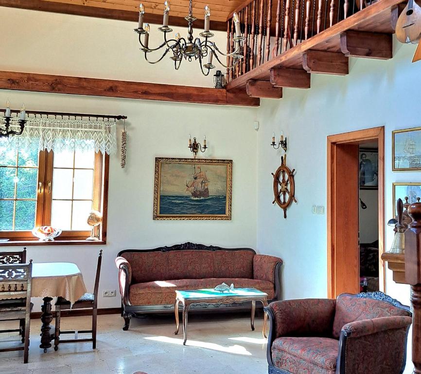 a living room with a couch and a table at REZYDENCJA BAŁTYCKA Sea and Forest KOPALINO in Kopalino