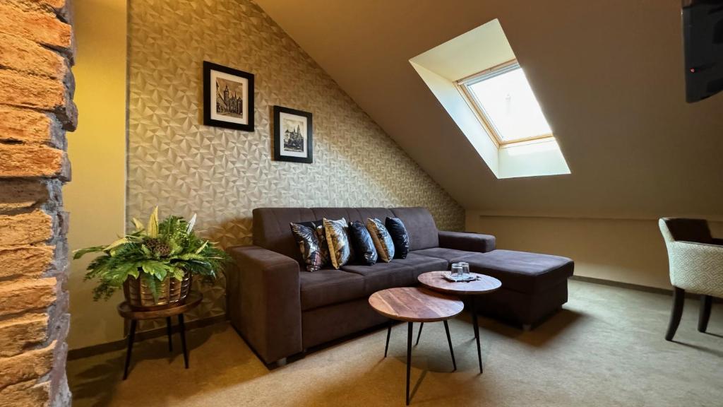 a living room with a couch and a window at Penzion Villa Regia in Košice