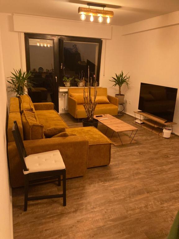 a living room with couches and a flat screen tv at Nice Cozy Appartment Remich in Remich