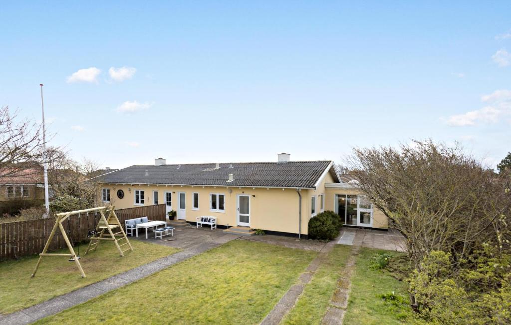 a house with a playground in the yard at Amazing Home In Skagen With Kitchen in Skagen