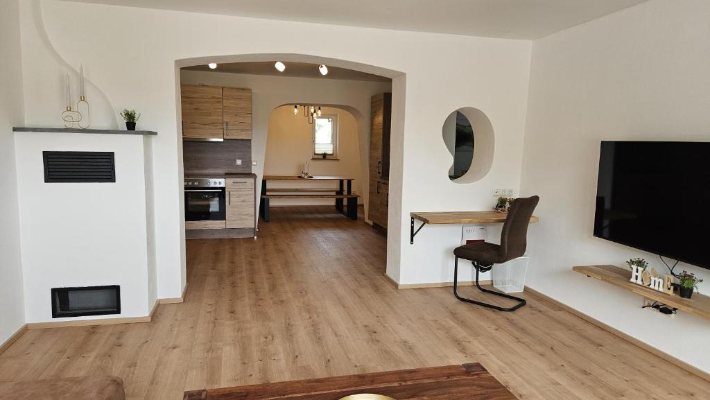 a living room with a television and a wooden floor at wohnung-nummer-4 in Pielenhofen