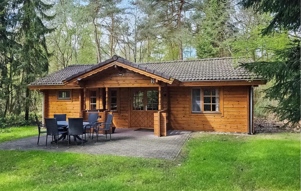 a log cabin with a table and chairs in the yard at Lovely Home In Neede With Sauna in Neede