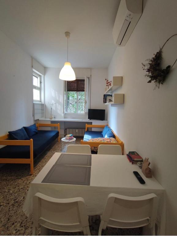 a living room with a couch and a table and chairs at Gavirate House MM Lotto in Milan