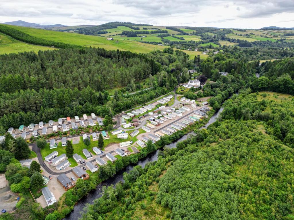 an aerial view of a village with a river at Corriefodly Holiday Park in Blairgowrie