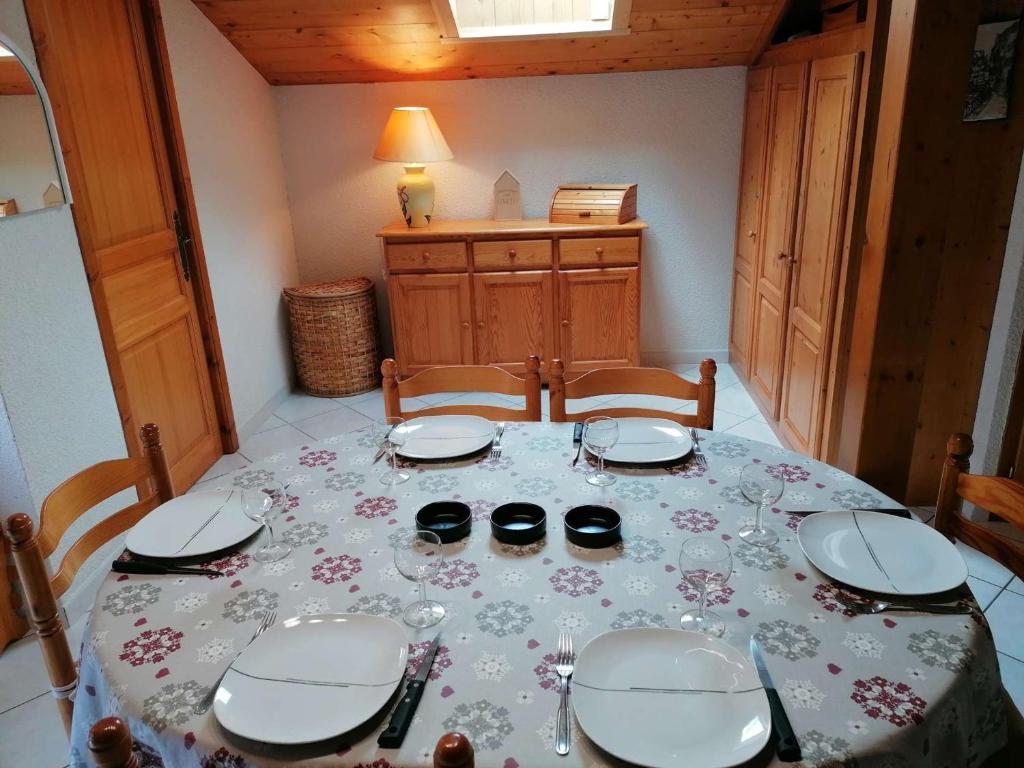 a table with plates and glasses on top of it at Appartement Le Grand-Bornand, 3 pièces, 6 personnes - FR-1-241-61 in Le Grand-Bornand