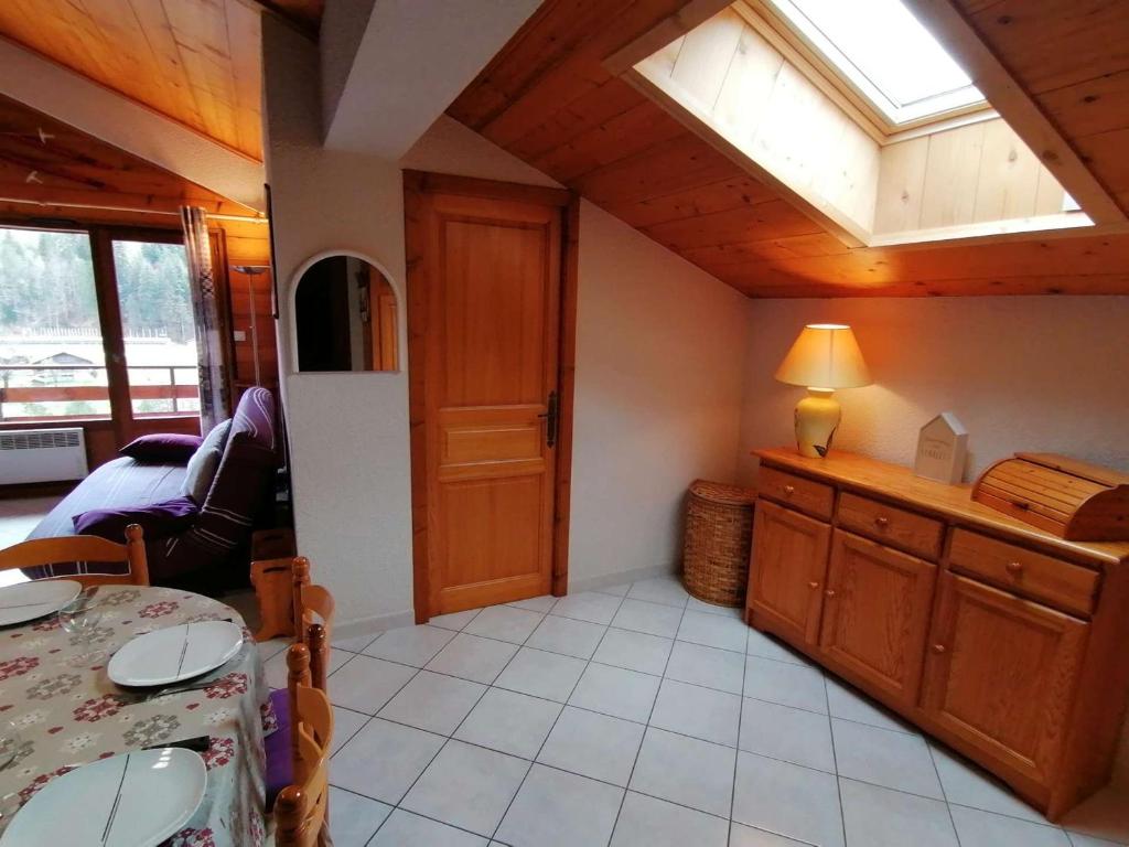 a kitchen with a table and a skylight in a room at Appartement Le Grand-Bornand, 3 pièces, 6 personnes - FR-1-241-61 in Le Grand-Bornand