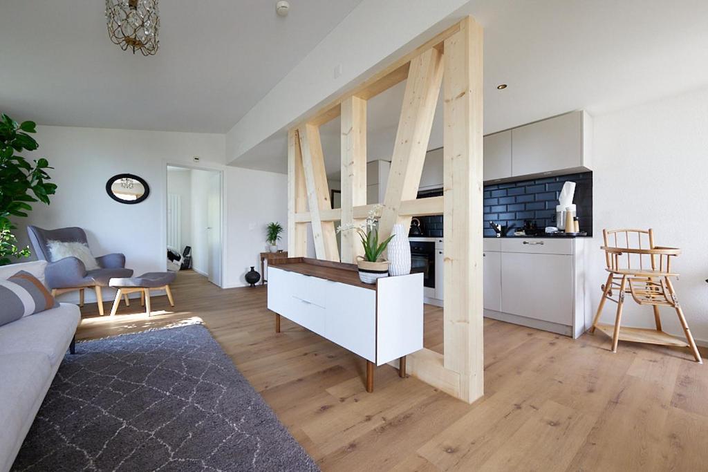 a large living room with a kitchen and a living room at Gantrisch Lodge Ottenleuebad in Guggisberg