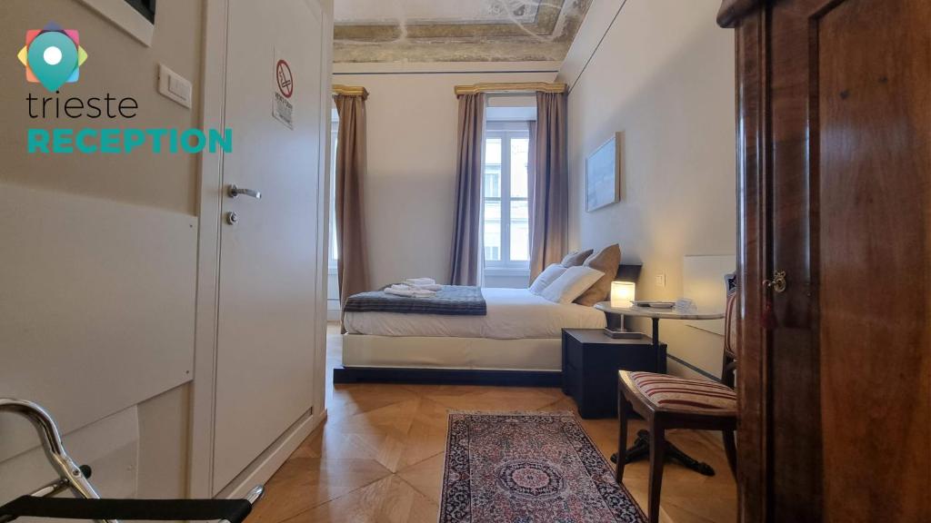 a small bedroom with a bed and a window at Le Saline Luxury Guest House in Trieste