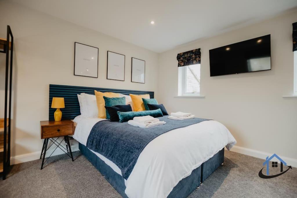 a bedroom with a large bed and a television at Shambles Retreat - Nr Bath king or twin beds free parking x2 in Bradford on Avon