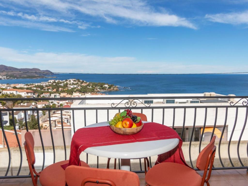 a table with a bowl of fruit on a balcony at Apartment Neptuno by Interhome in Llança