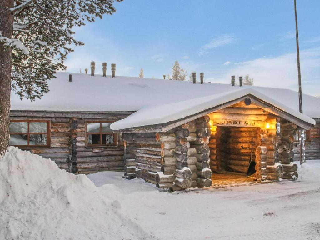a log cabin with a snow covered roof at Holiday Home Lomarati 3 by Interhome in Saariselka