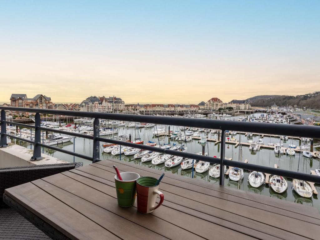 a balcony with a view of a marina with boats at Apartment Les Lofts-17 by Interhome in Dives-sur-Mer
