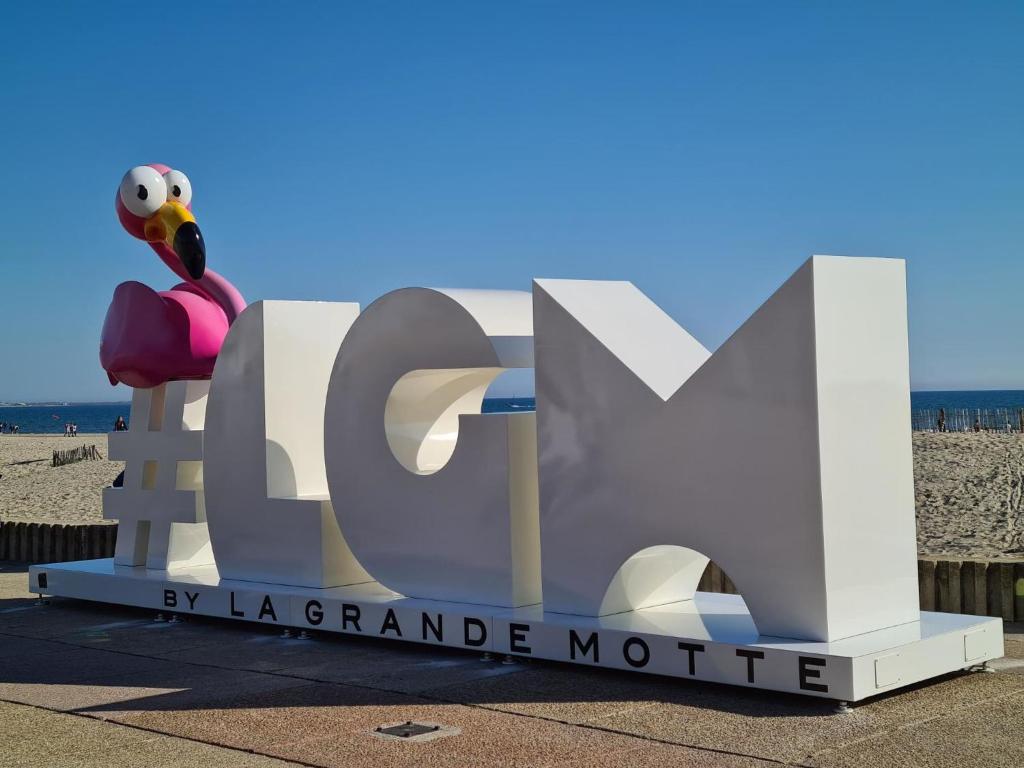 a large sign at the beach with a hello kitty statue at Studio East Land-3 by Interhome in La Grande Motte