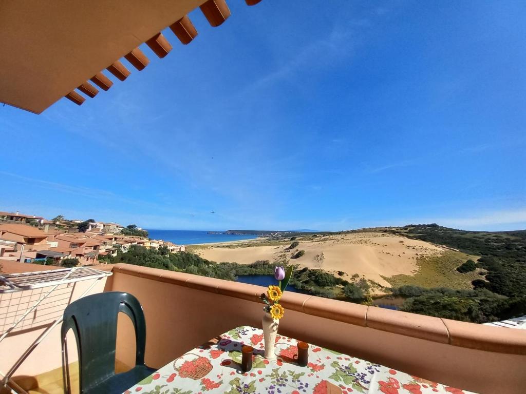 a table on a balcony with a view of a beach at Casa Maci in Torre Dei Corsari