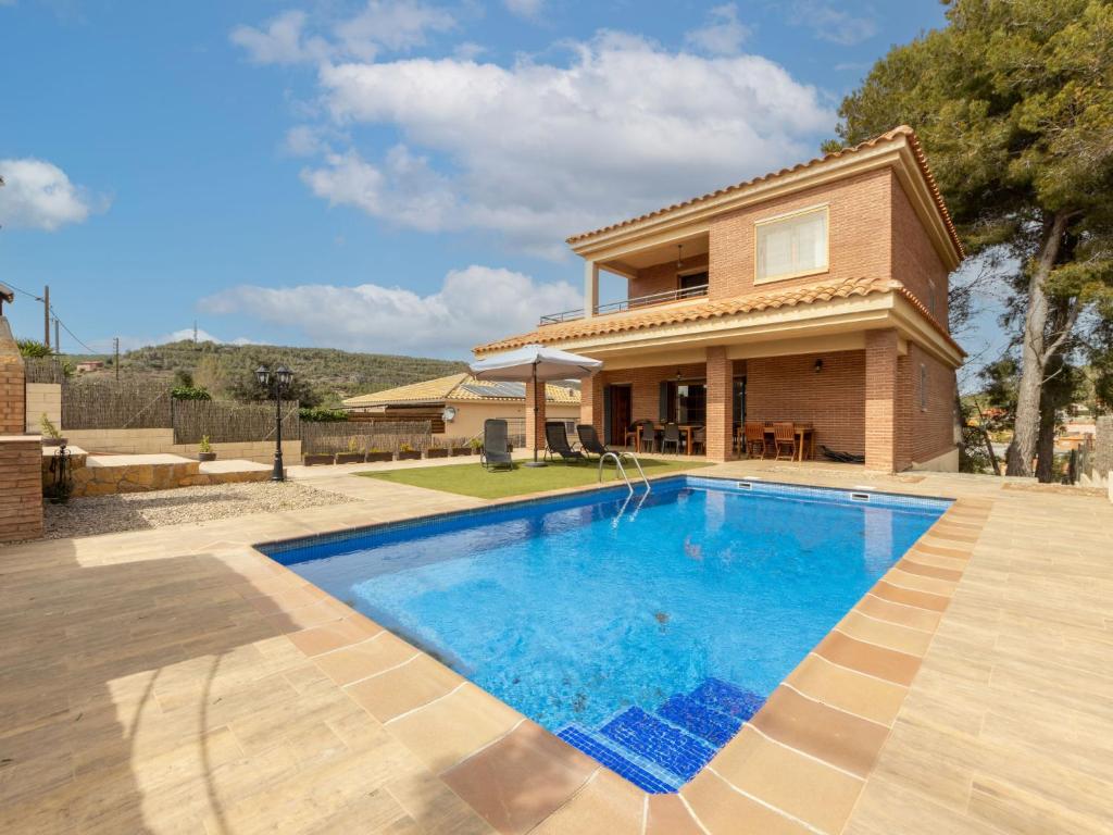 a house with a swimming pool in front of a house at Holiday Home Jose Ramon by Interhome in Vespellá