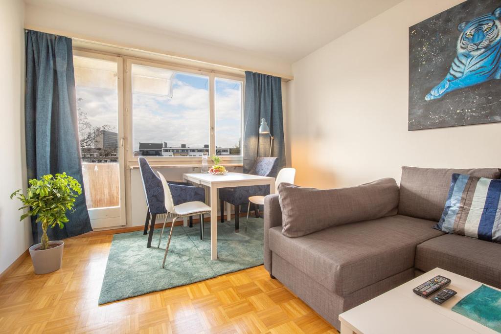 a living room with a couch and a table at Special BLUE TIGER Apartment Basel, Messe Kleinbasel 10-STAR in Basel