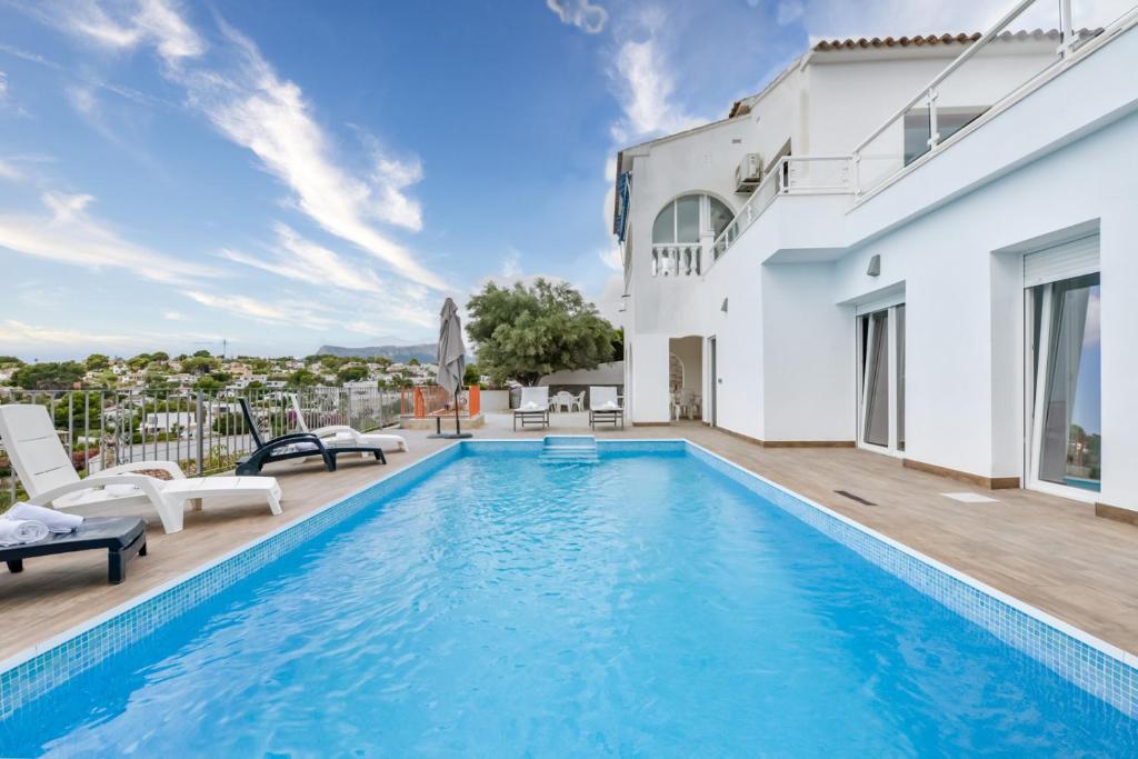 a villa with a swimming pool and a patio at Villas Guzman - Alex in Benissa
