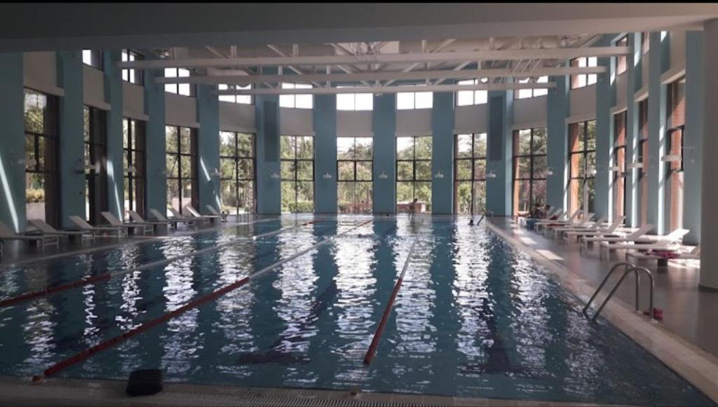 an indoor swimming pool with a large pool at tbilisi garden 2 in Tbilisi City