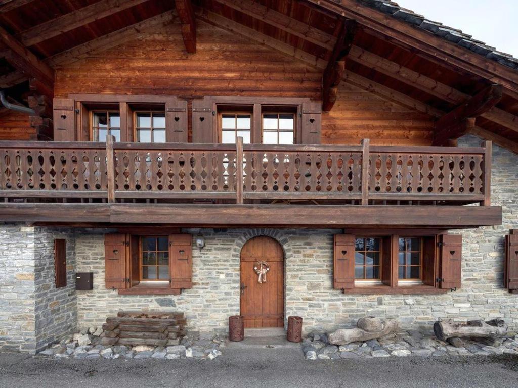 a wooden house with a balcony on top of it at 5 bedroom luxury Chalet by Dieckereise in Verbier