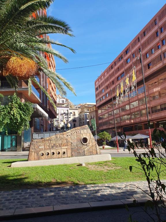 a monument in the middle of a city with buildings at LaRambla Alicante City 3 Bdrm in Alicante