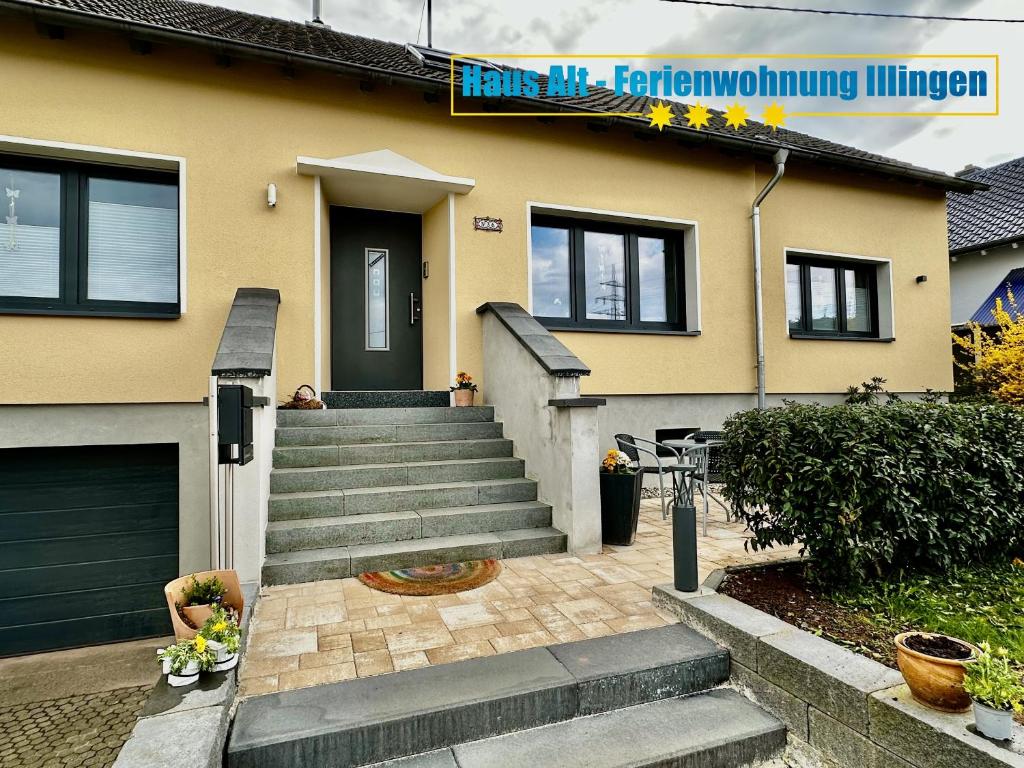 a house with a staircase leading to the front door at Haus Alt - Ferienwohnung in Illingen