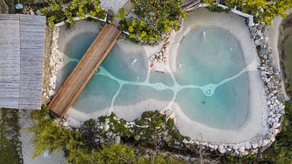 an aerial view of a pool of water with a wooden pole at Giardini Penelope in Ciampino