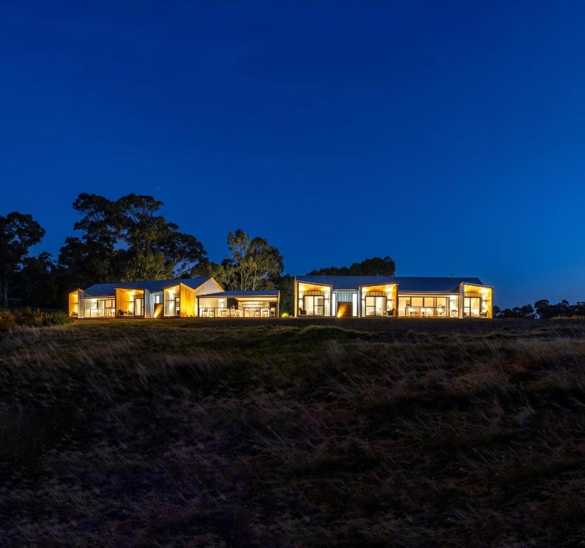 Una casa iluminada por la noche en un campo en Benbullen Retreat en Angaston